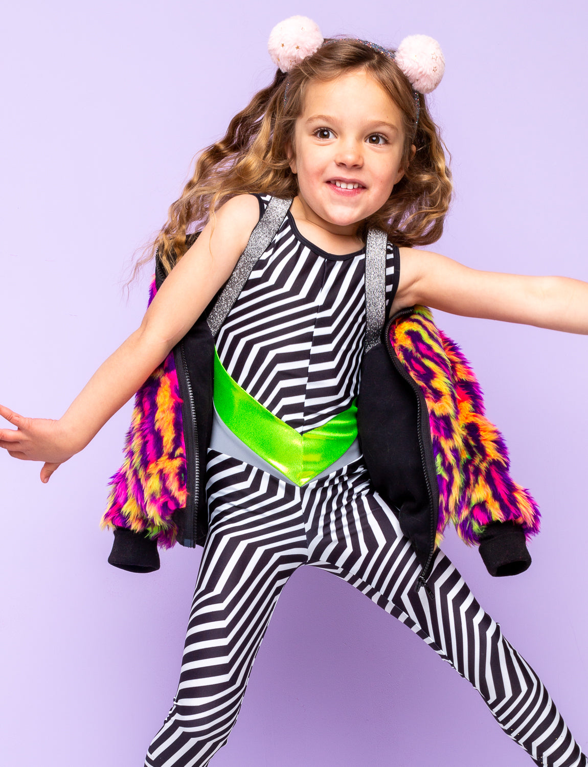 Girl wearing a black and white striped catsuit with lime green panels..