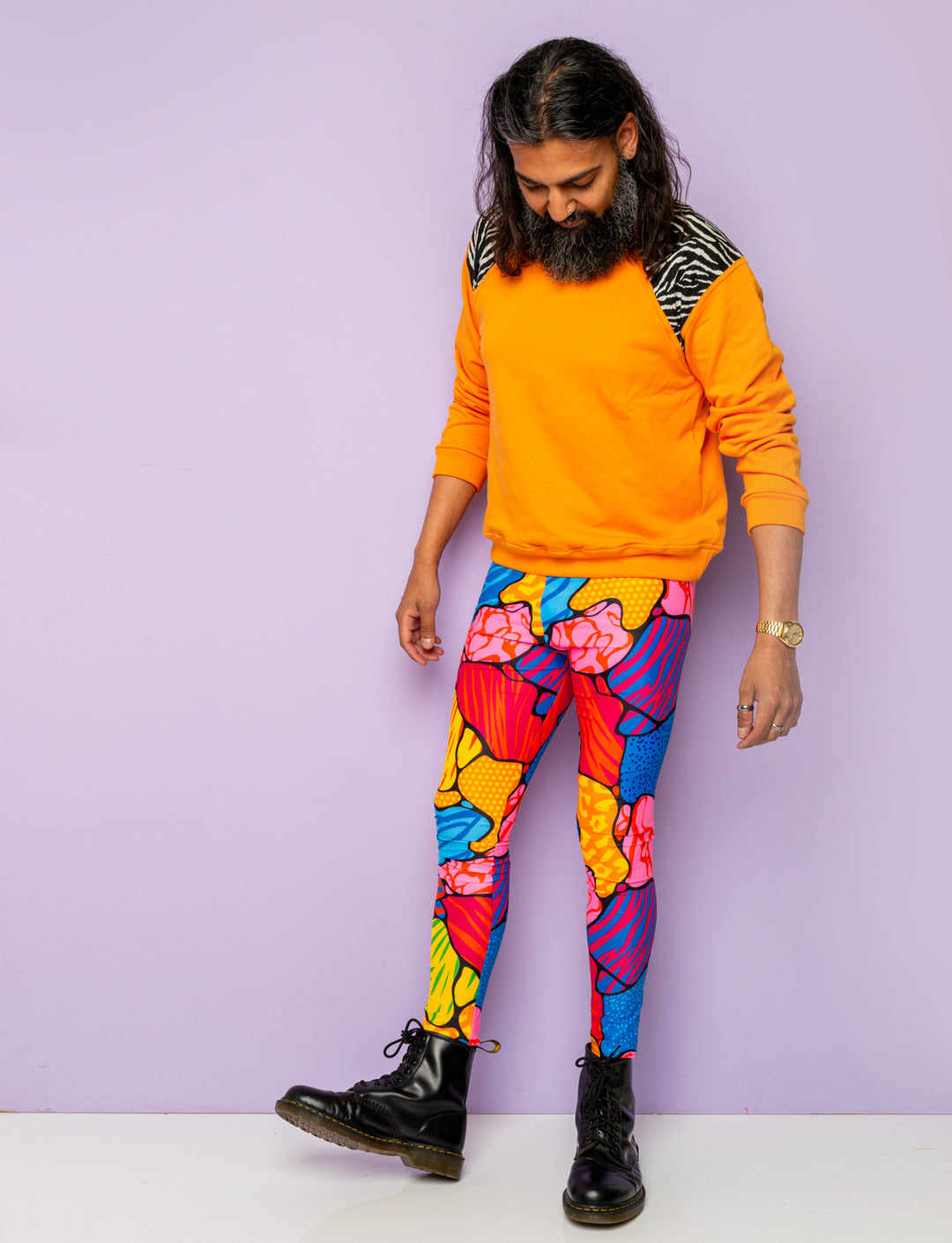 Guy modelling multi coloured animal print mens leggings.