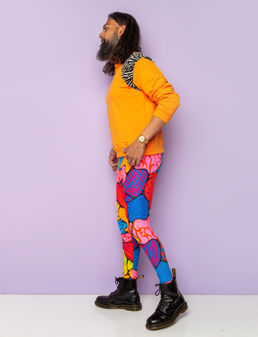 Guy modelling multi coloured animal print mens leggings.