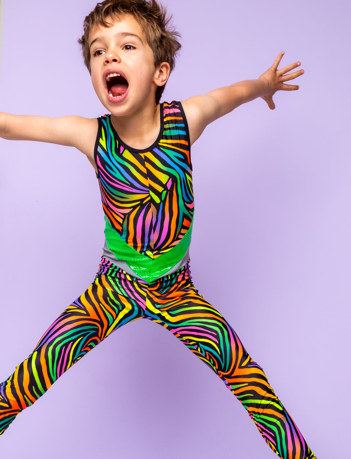 Boy jumping in the air modelling a multi coloured zebra print lycra catsuit.