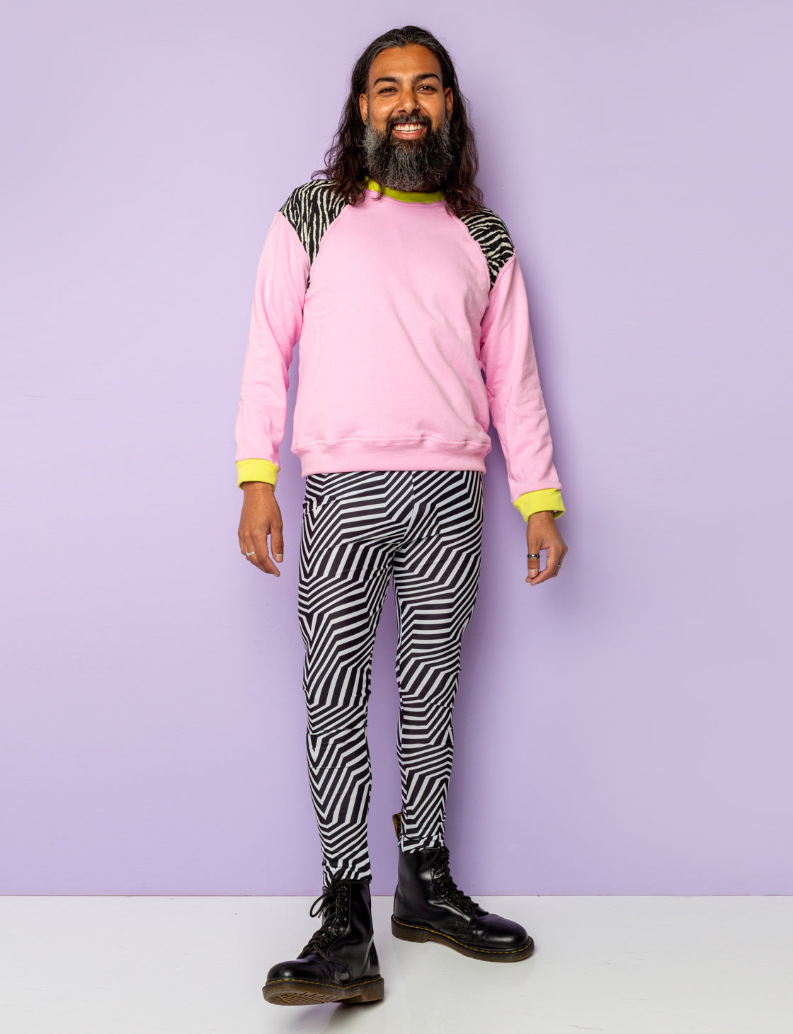 Man models black and white psychedelic strip leggings.
