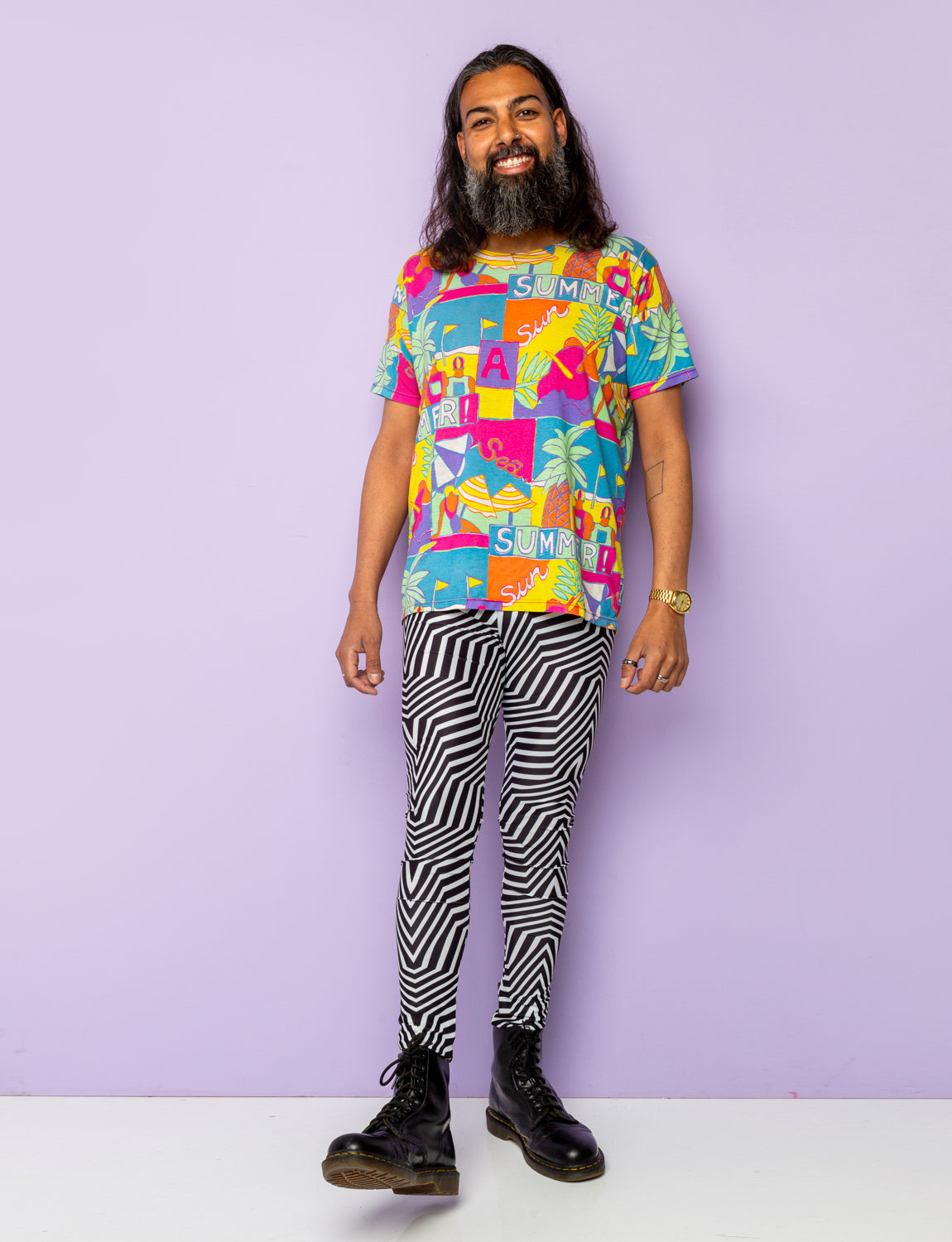 Man models black and white psychedelic stripe leggings.