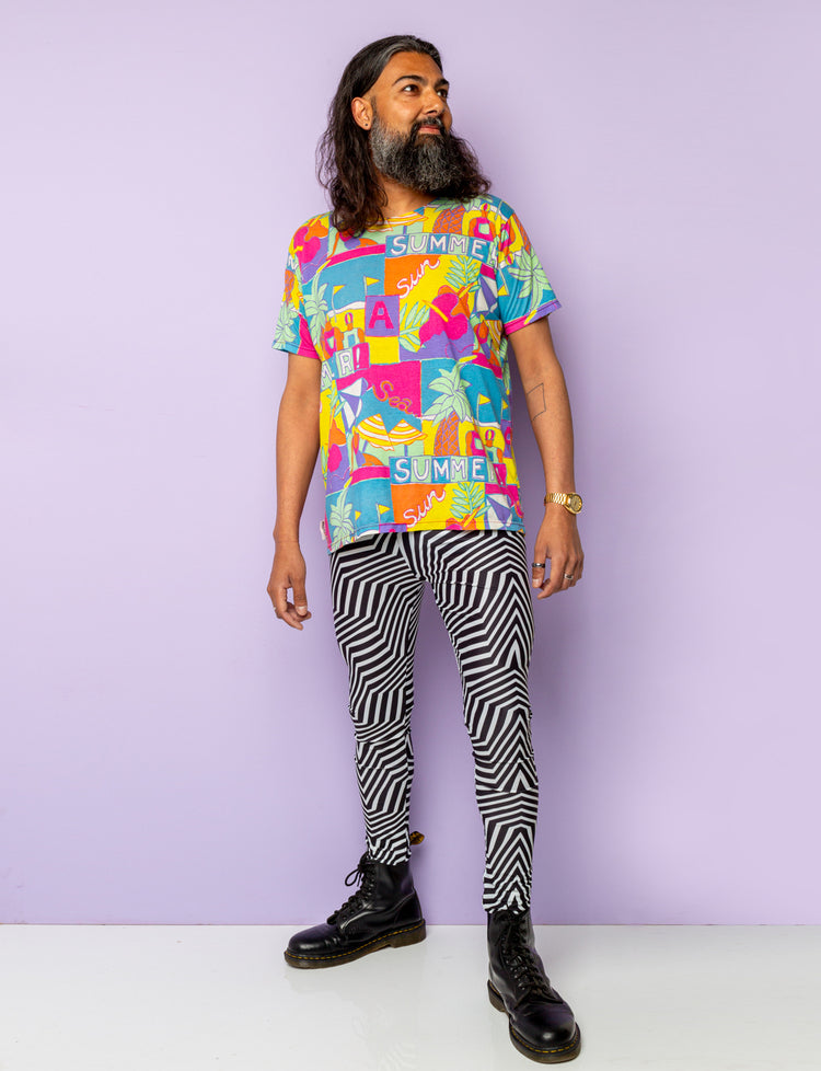 Man models black and white psychedelic stripe leggings.