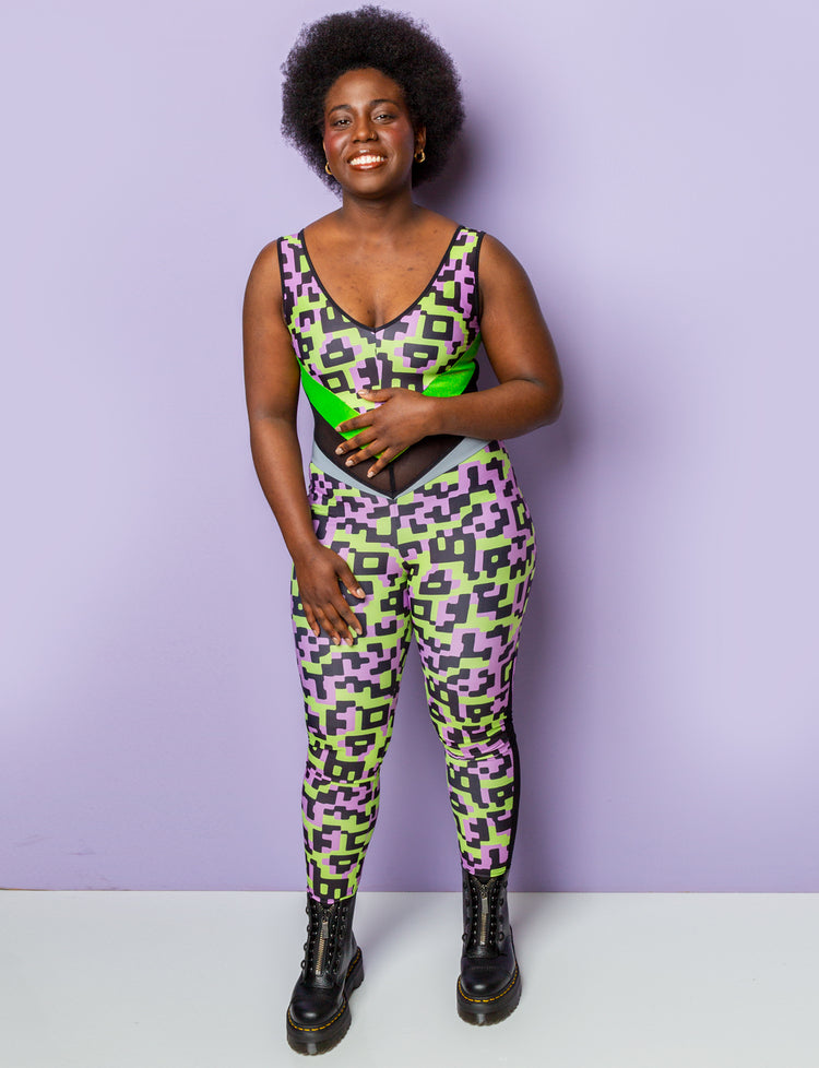 Woman wearing a lilac and lime green patterned lycra catsuit.