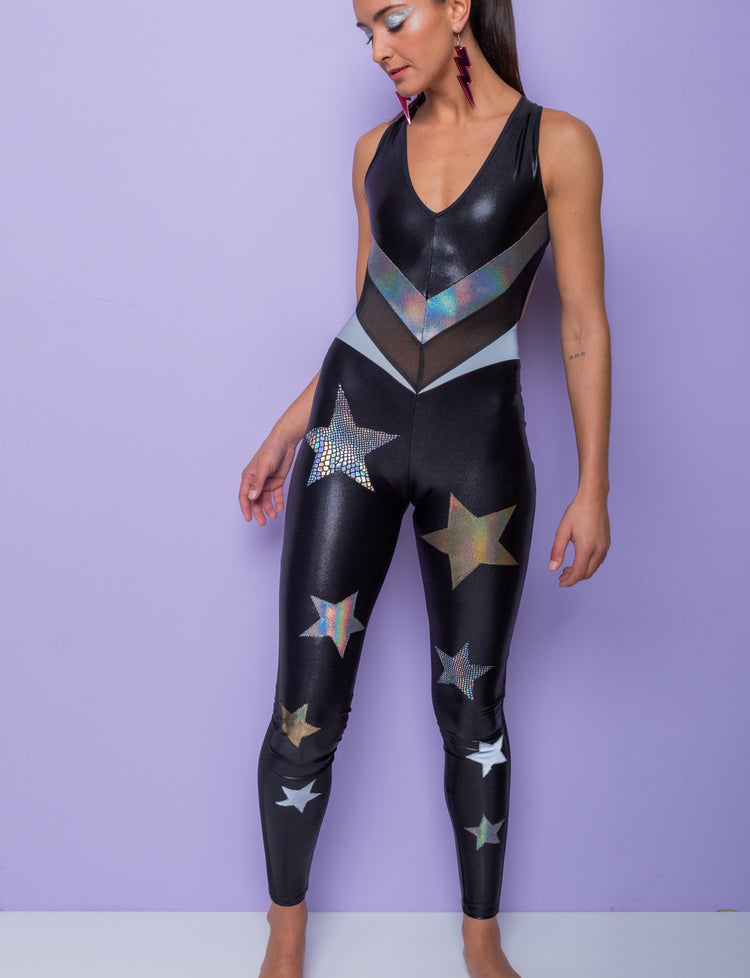 model wearing a sleeveless black catsuit by Burnt Soul with gold and silver stars