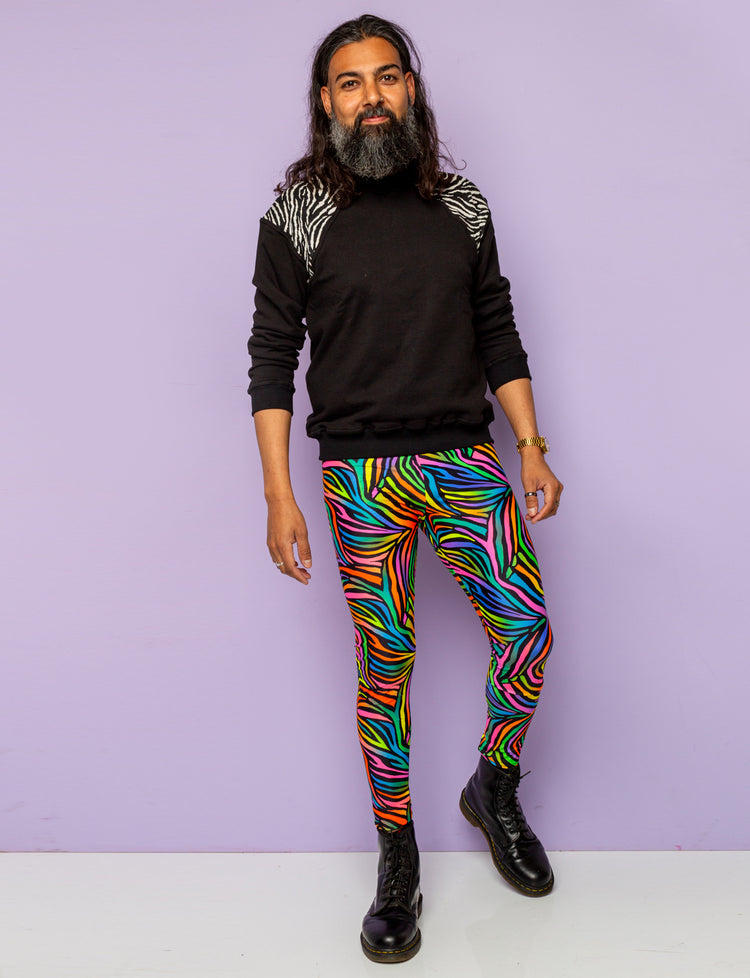 Man modelling rainbow zebra mens leggings and black zebra print sweatshirt.