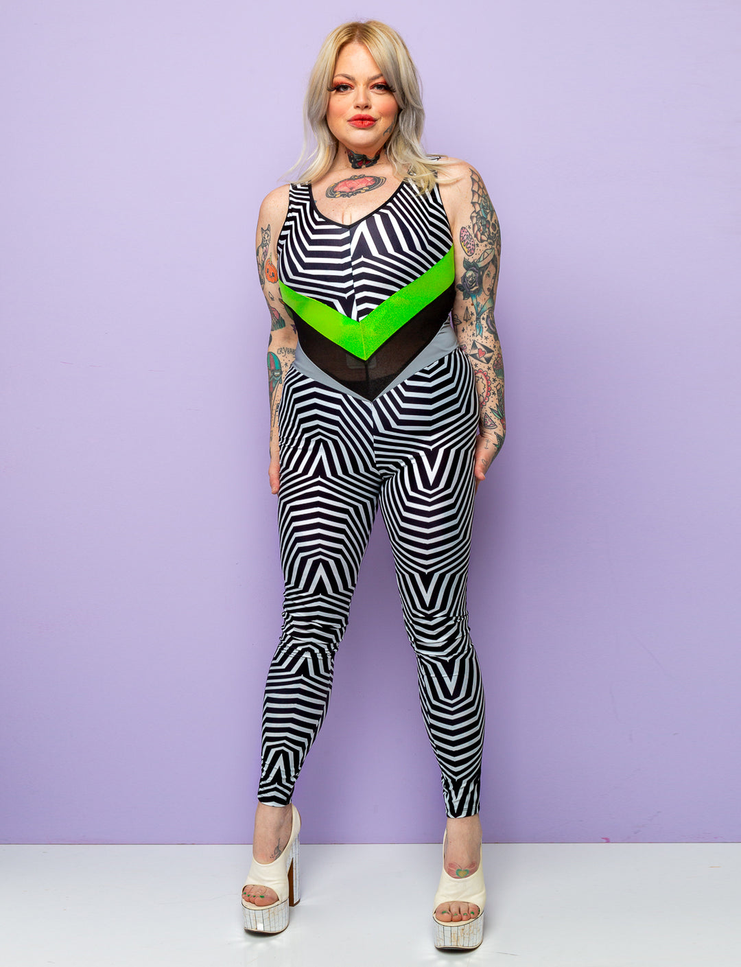 Woman modelling a black and white geometric printed lycra catsuit.