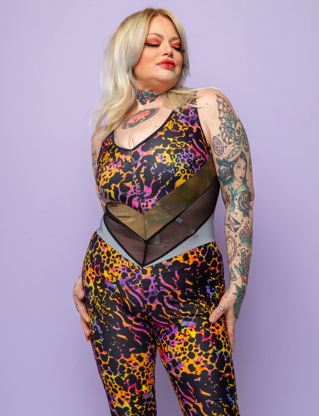 Woman modelling a purple leopard print lycra catsuit.