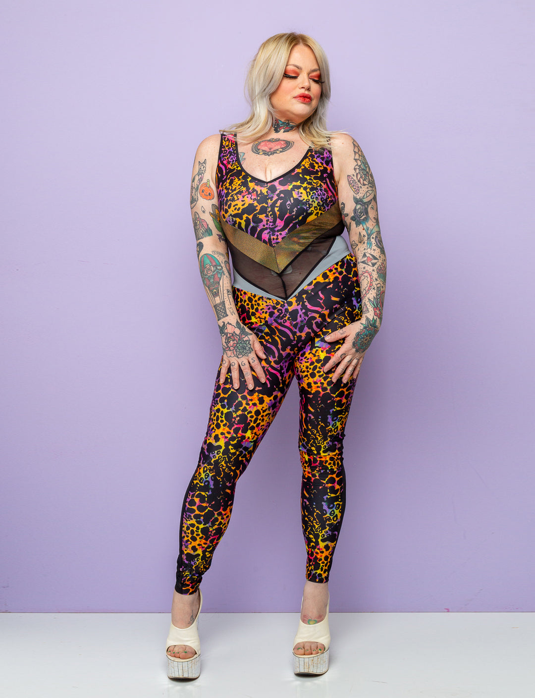 Woman modelling a purple leopard print lycra catsuit.