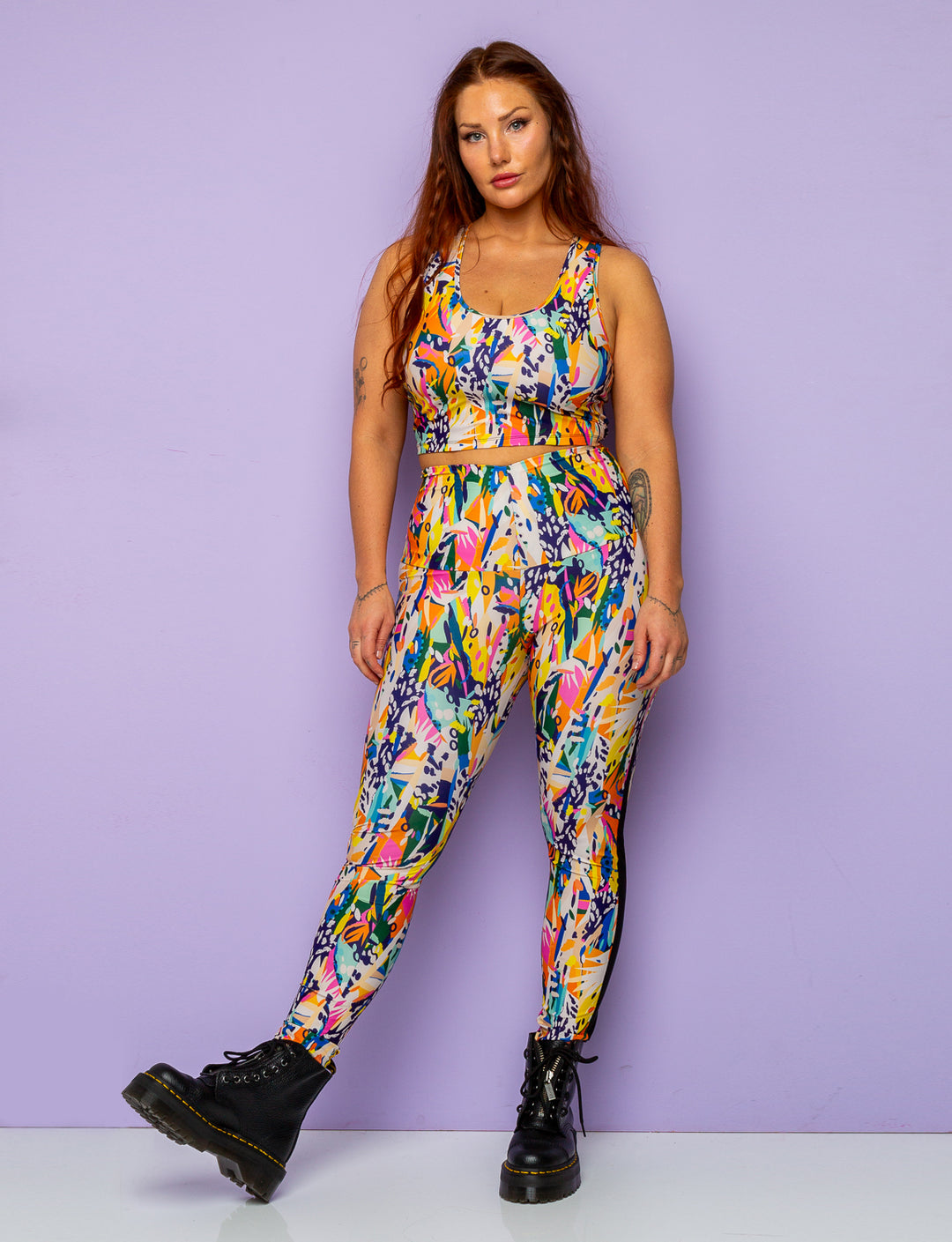 Woman with plaits in her hair modelling printed leggings with matching crop top.