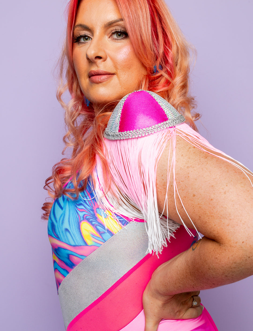 Woman modelling pink fringed shoulder pads.