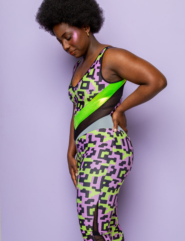 Side view of a woman wearing a lilac and lime green patterned lycra catsuit.