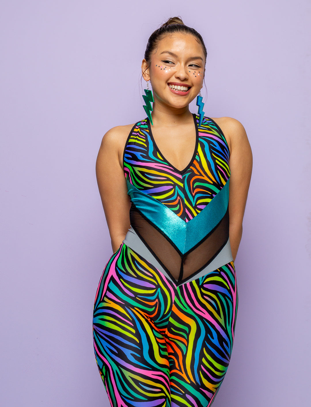 Woman modelling a multi coloured zebra print catsuit.
