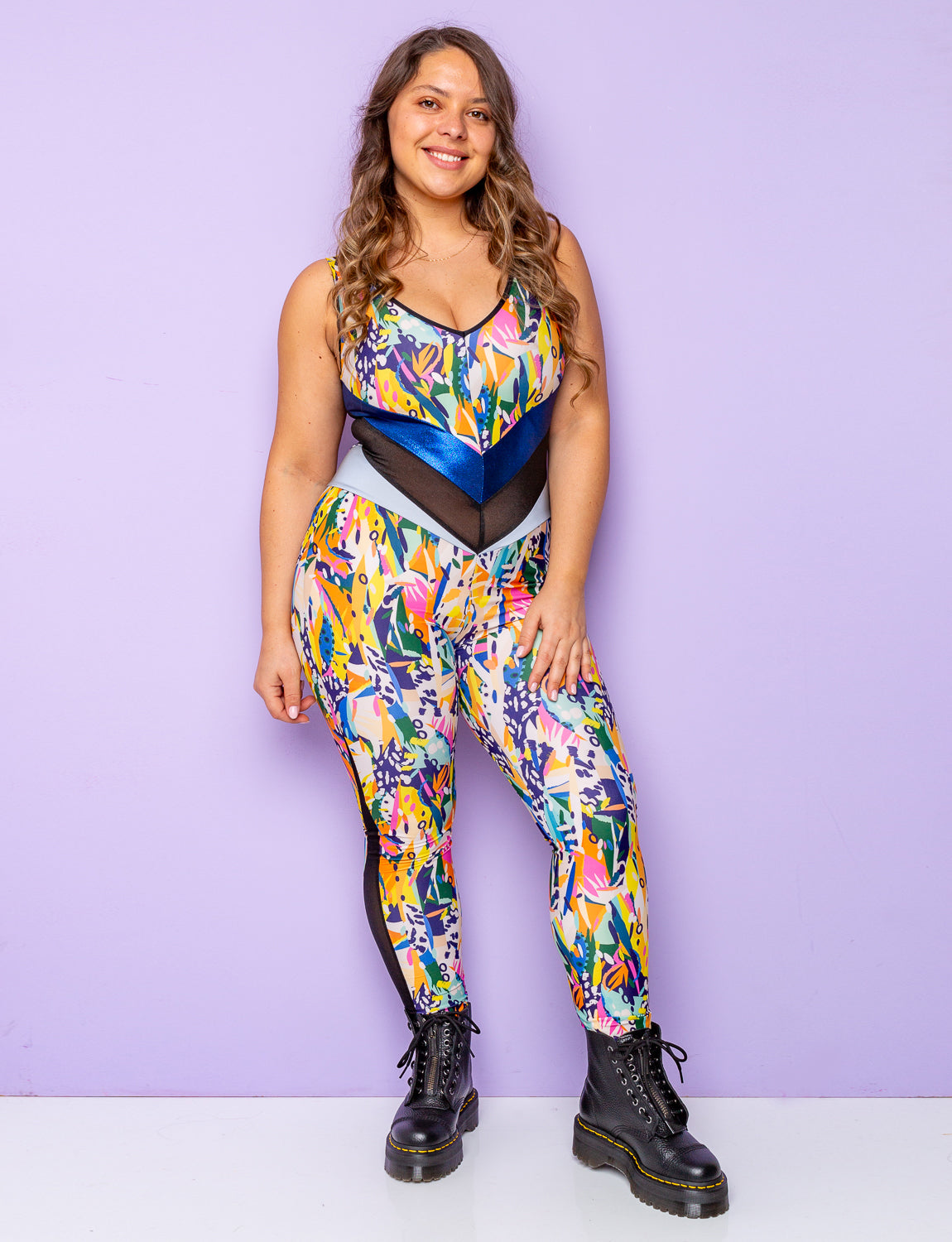 Woman modelling a jungle print lycra catsuit with contrasting waist panels.