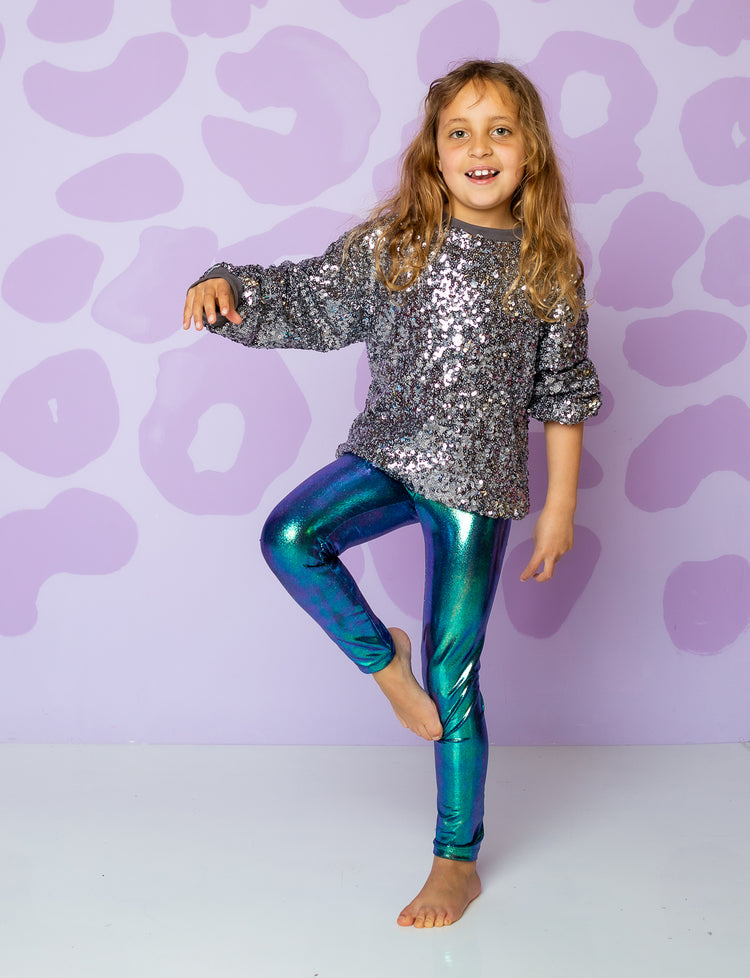 girl wearing leggings made from green shiny fabric
