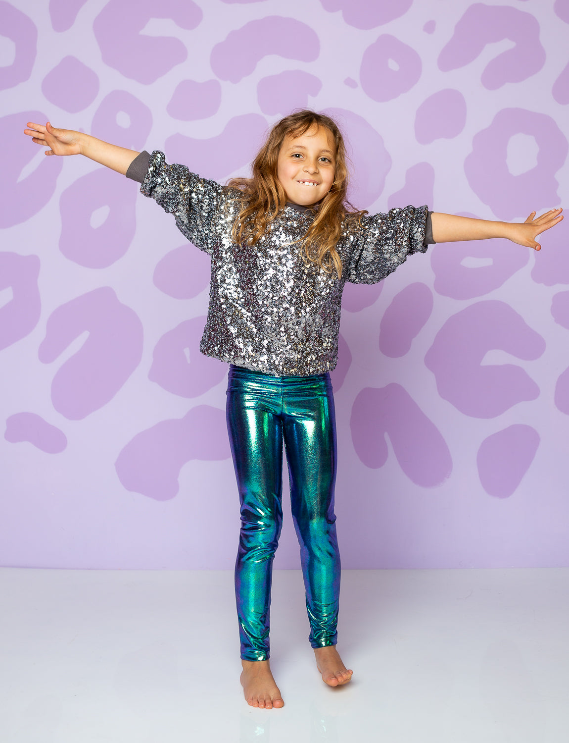 girl wearing leggings made from green shiny fabric