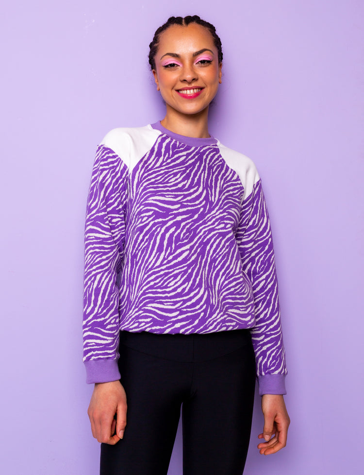 lilac and white zebra print sweatshirt tucked under at hips