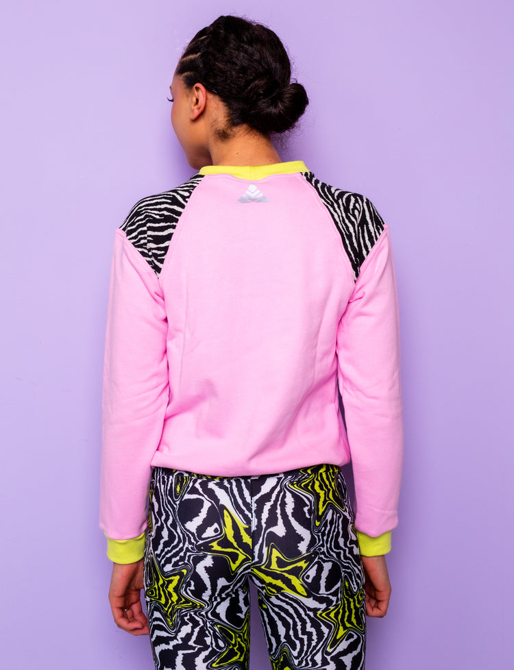 back view of a woman wearing a pink sweatshirt with zebra prints shoulders
