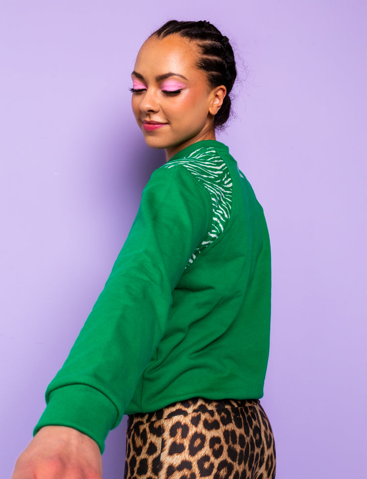 Green sweatshirt with zebra print shoulders