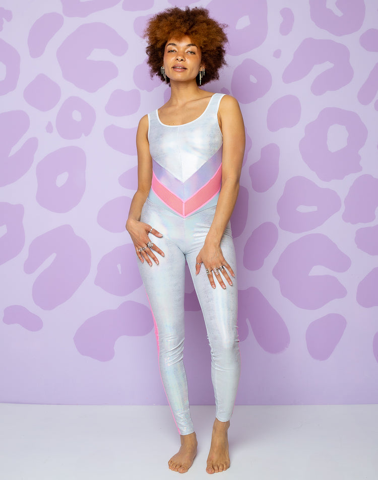 woman wearing white catsuit with lilac and pink panels in middle and pink mesh panels on side of legs
