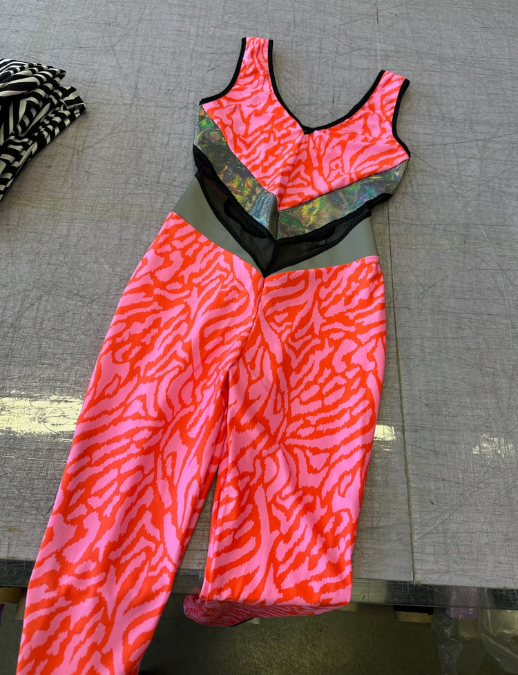 pink uv printed catsuit with metallic and mesh panels made from lycra