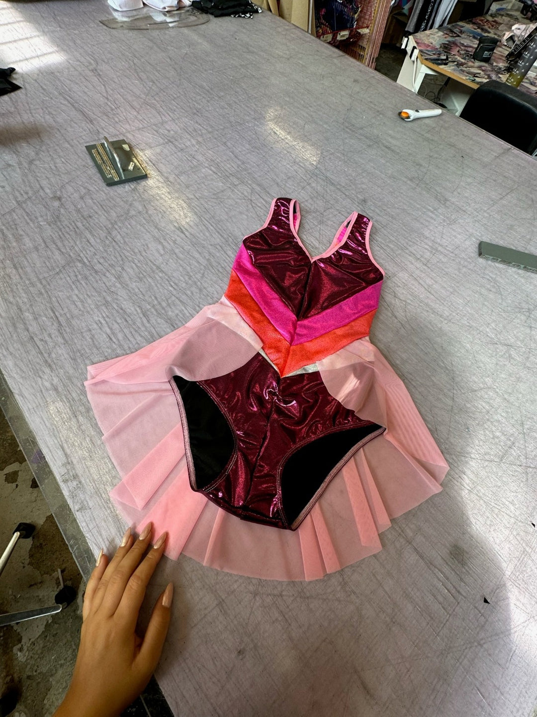 berry coloured lycra leotard with orange and pink panels and pink skirt