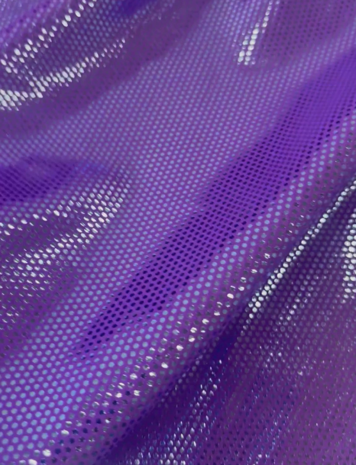 Blue spotted foil on purple stretch fabric.