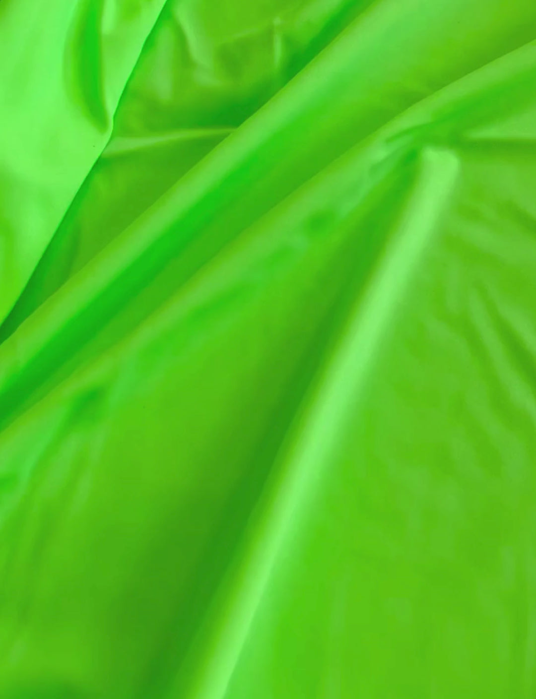 Lime green plain lycra fabric.