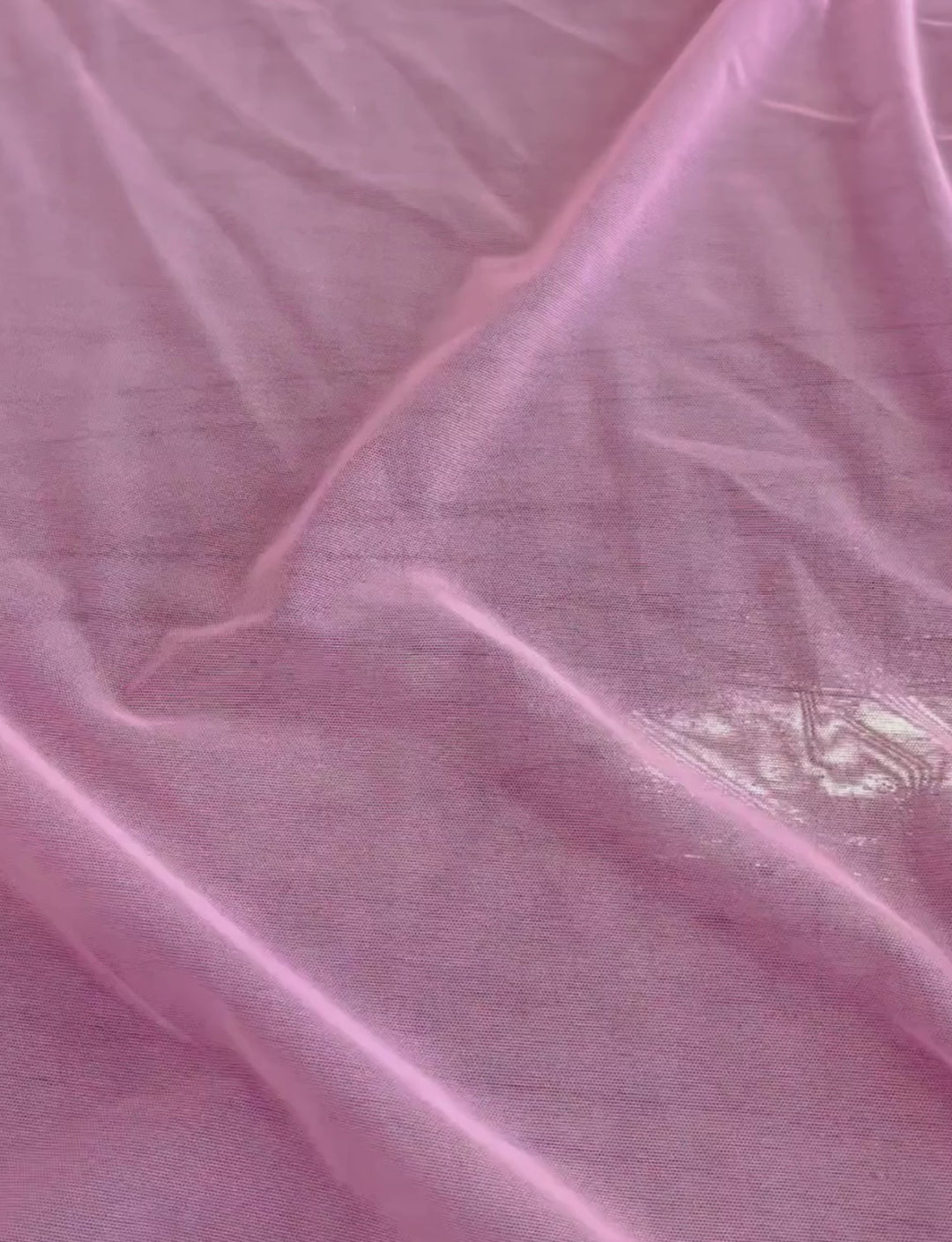 Sheer pink mesh stretch fabric.