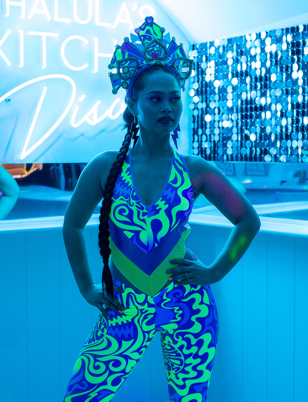 woman in uv patterned catsuit with matching crown